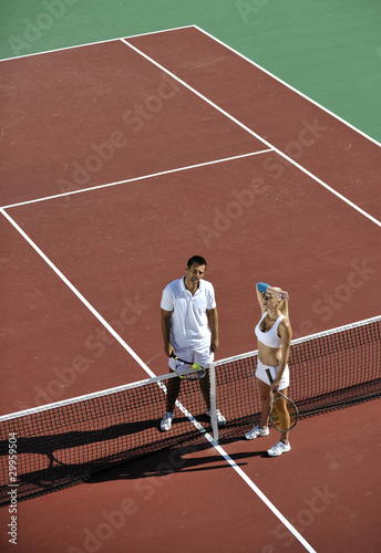 happy young couple play tennis game outdoor © .shock