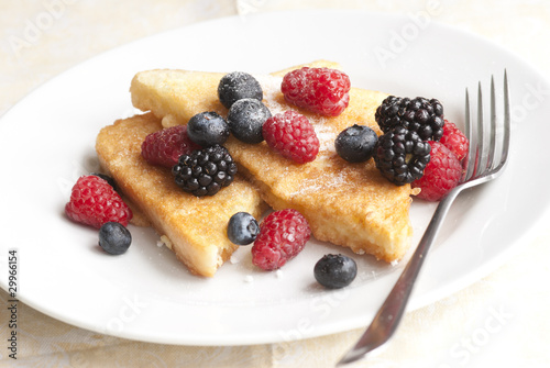 French toasts with fresh berries on a plate