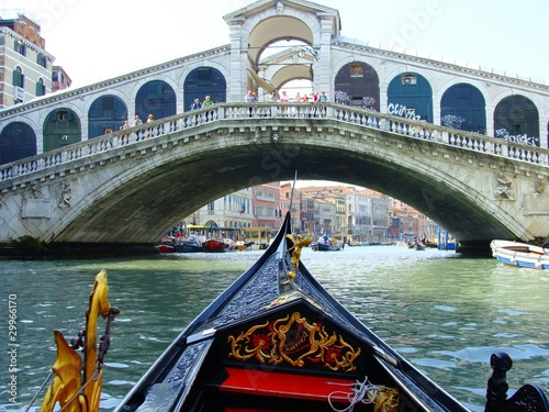 A Gondola Glides Under the Rialto Bridge in Venice Italy