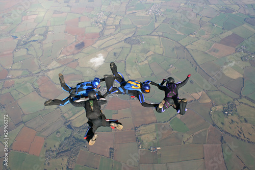 Four skydivers training