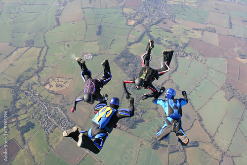 Four skydivers training