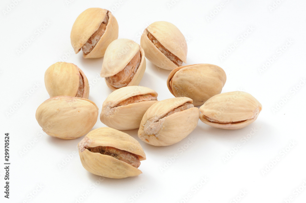 Roasted and salted pistachio nuts on white background Roasted and salted pistachio nuts on white background