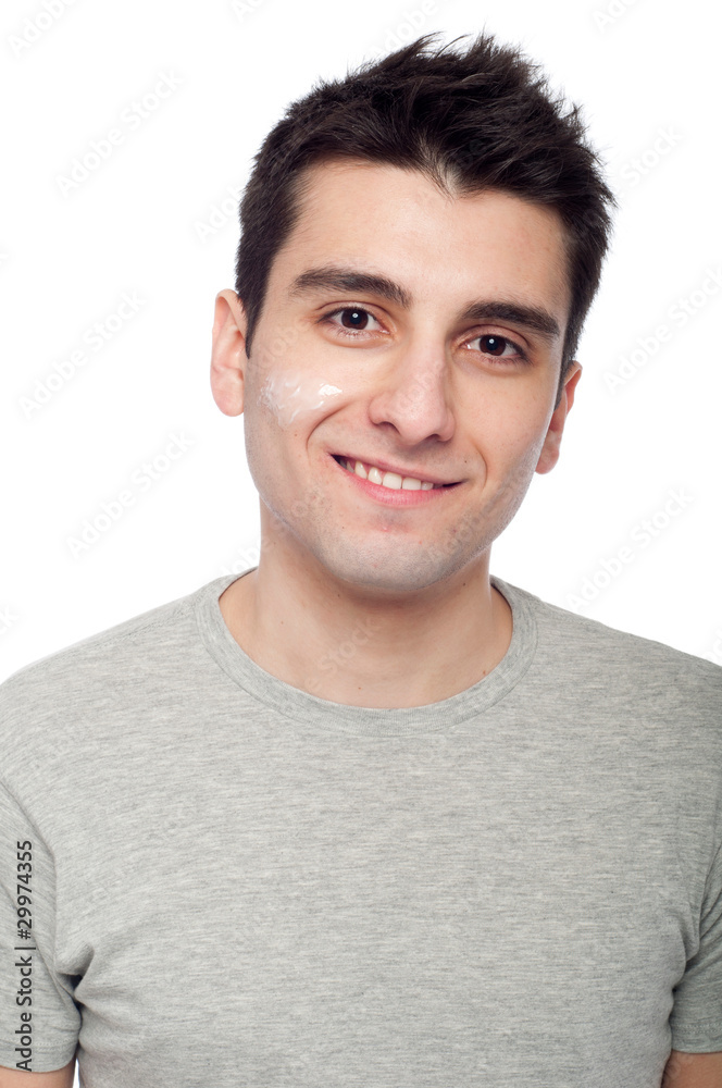 Obraz premium Young man with cream lotion