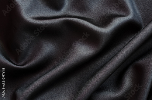 Photo d'un arrière-plan de tissu en soie ou satin noir, texture satinée, luxe et douceur photo
