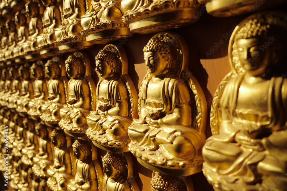 Fototapeta premium Statues of Amitabha Buddha on the wall