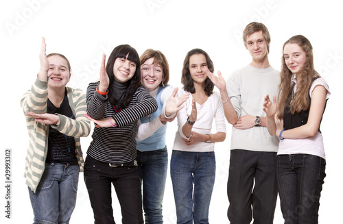 Group of teenagers pull hands that them have seen
