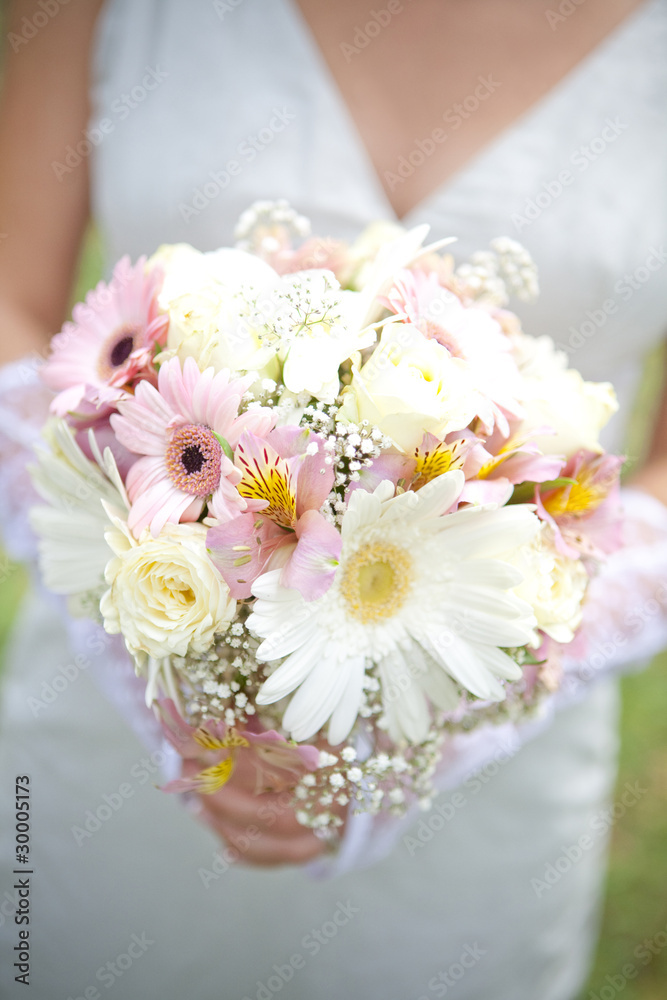 The bride have pink wedding bouquet