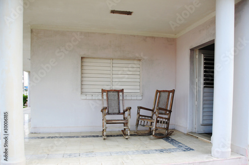 Two old wooden chairs on the porch