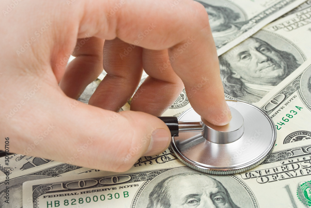 Fotografie Hand with stethoscope and money