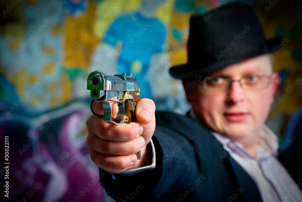 Fototapeta premium man aiming with gun. Close-up shot on gun