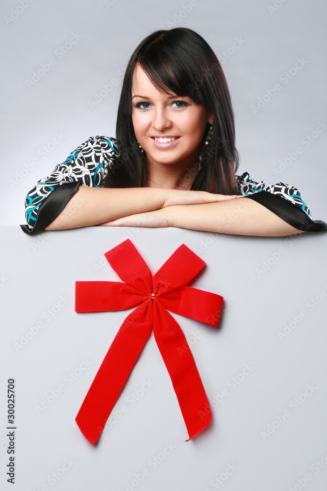 Gorgeous smiling brunette on a grey presentation board Gorgeous smiling brunette on a grey presentation board
