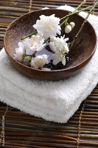 cherry blossom in wooden bowl on towel