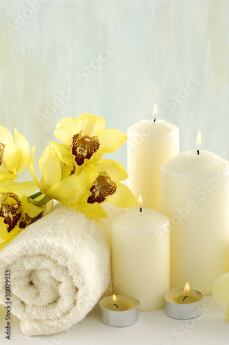 Spa composition  white towel and yellow orchids on towel 