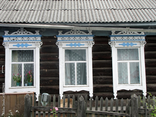 carved windows of old wooden house.