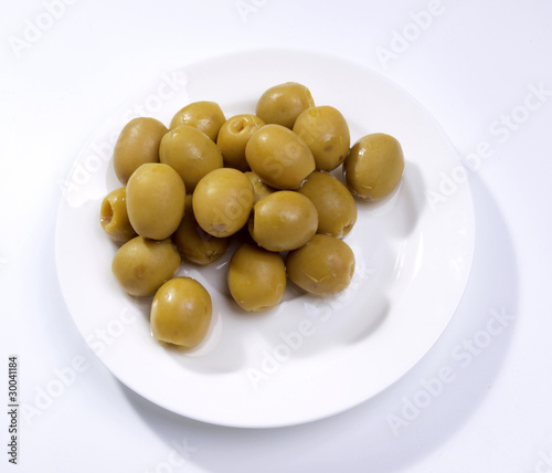 Green olives on fork