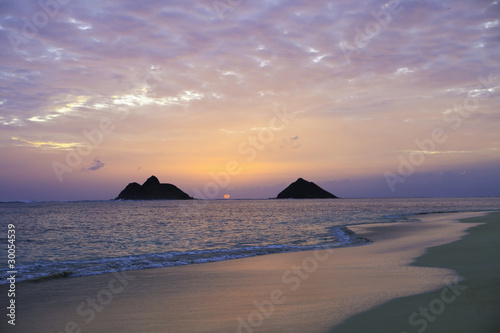 pacific sunrise between the mokulua islands in hawaii