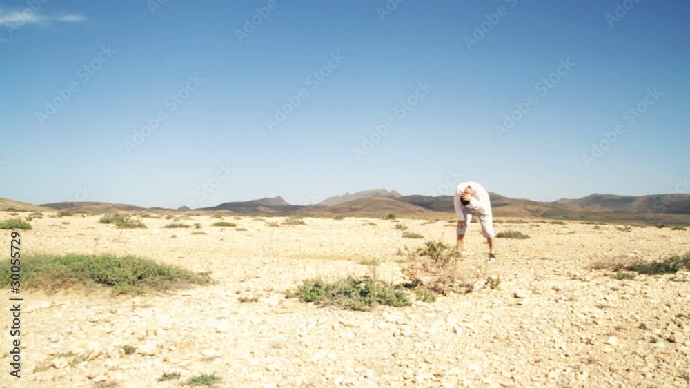 Athletic young man running at the desert, slow motion Athletic young man running at the desert, slow motion
