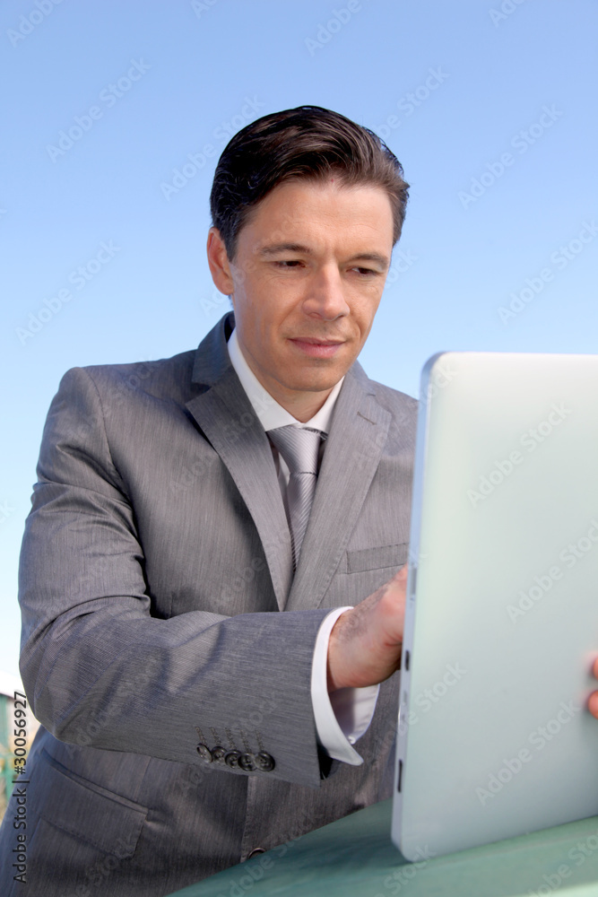 Portrait of businessman working on electronic tablet Portrait of businessman working on electronic tablet