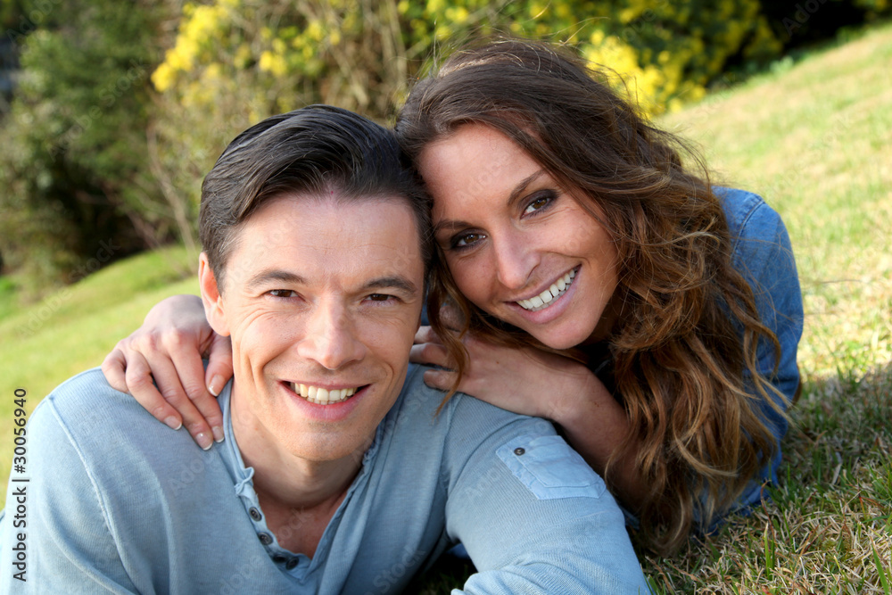 Couple relaxing in home garden