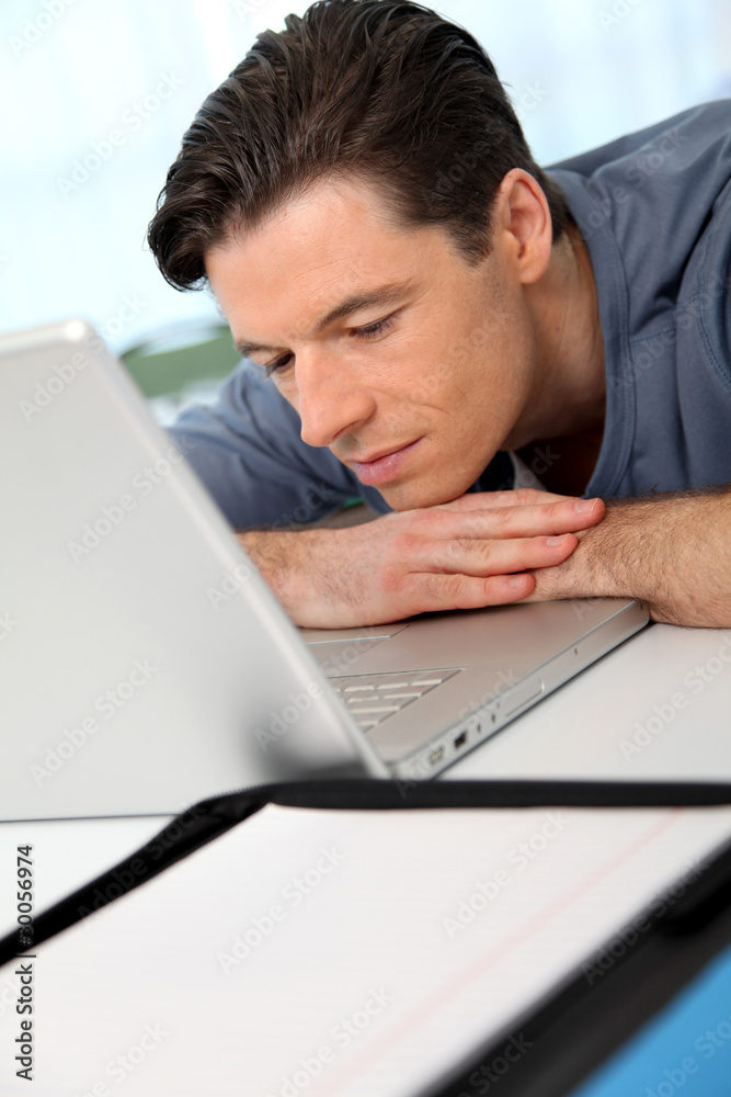 Office worker with exhausted look in front of computer Office worker with exhausted look in front of computer