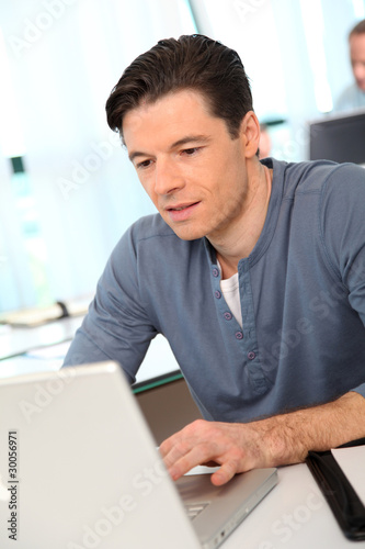 Portrait of office worker in front of laptop computer
