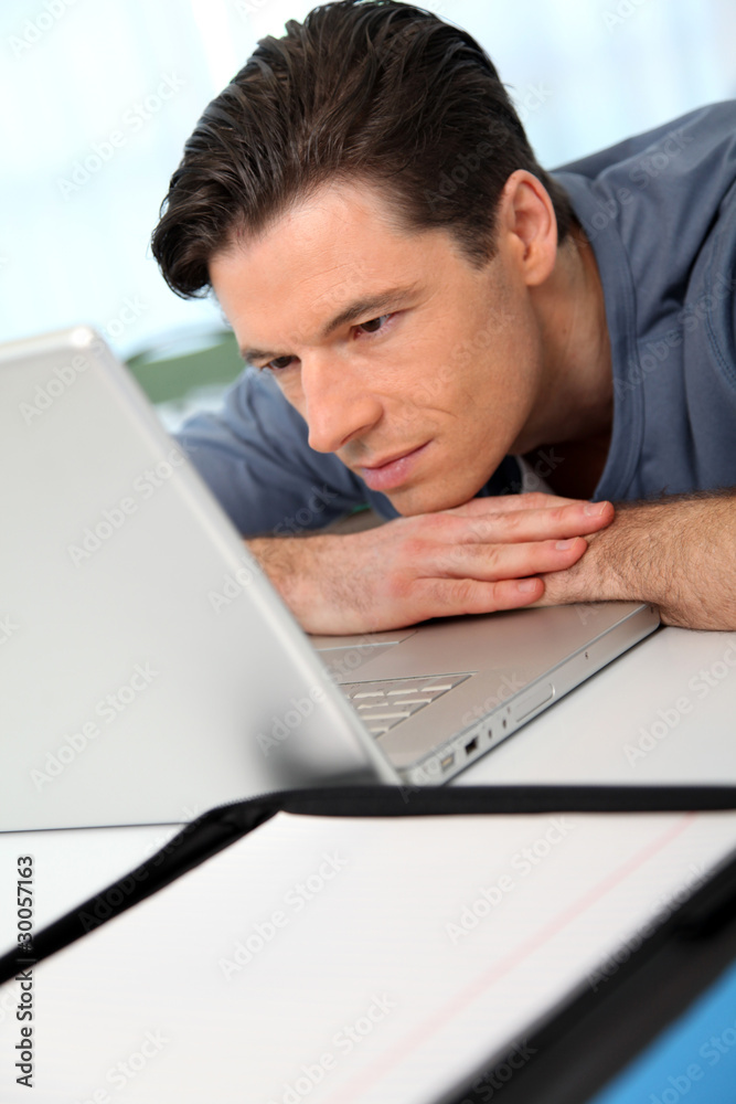 Office worker with exhausted look in front of computer Office worker with exhausted look in front of computer