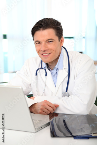 Portrait of smiling doctor working in the office