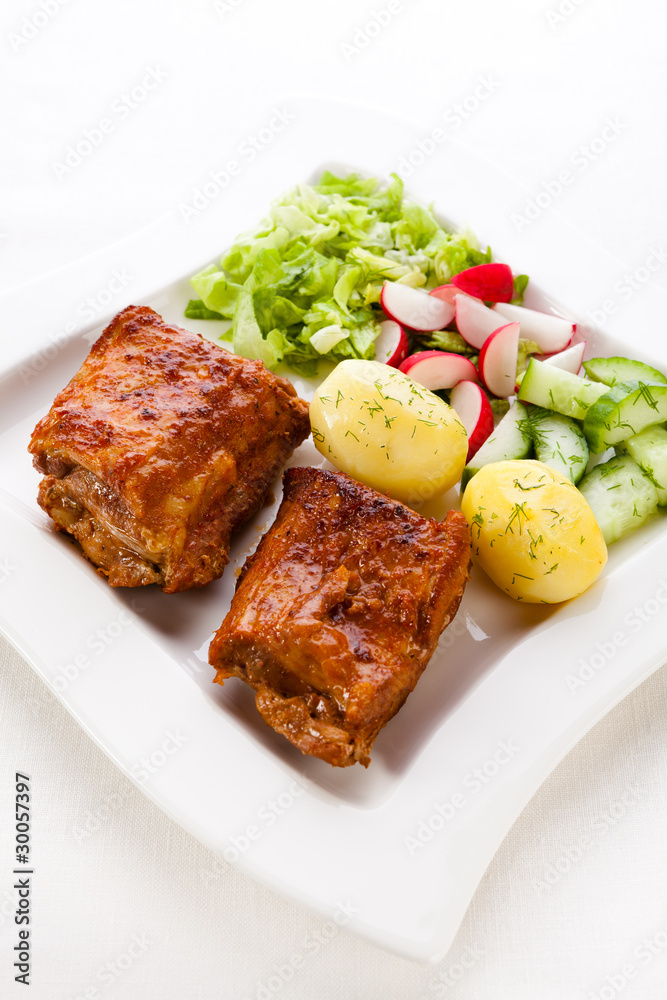 Tasty grilled ribs with vegetables Tasty grilled ribs with vegetables