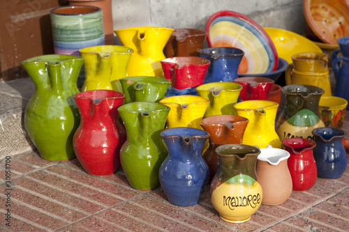 Colorful souvenir jugs for sale outside shop in Majorca, Spain