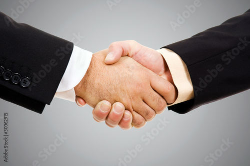 Closeup of business people shaking hands at the office