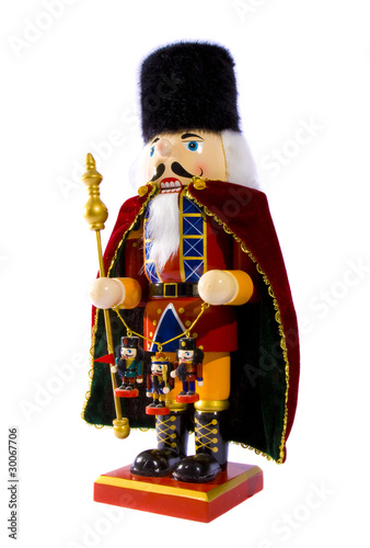 Wooden nutcracker with three small nutcrackers isolated