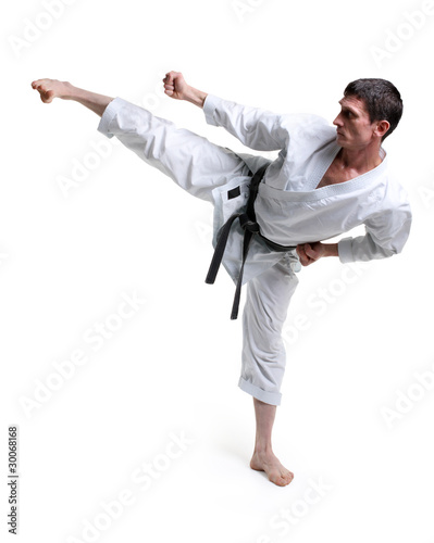Karate. Man in a kimono hits foot