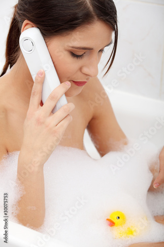 Beautiful young woman talking by phone