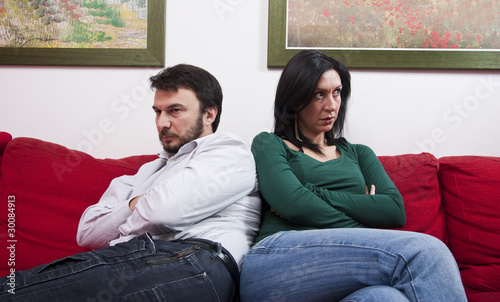 Angry Adult Couple Sitting on Sofa