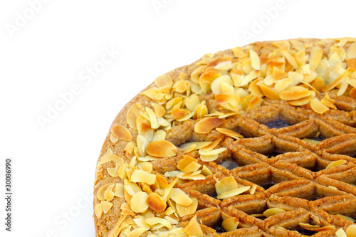 Quadro em tela Linzer torte pie half with almonds detail on white background