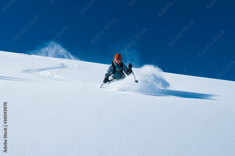 Obraz premium mature woman skiing un tracked powder snow