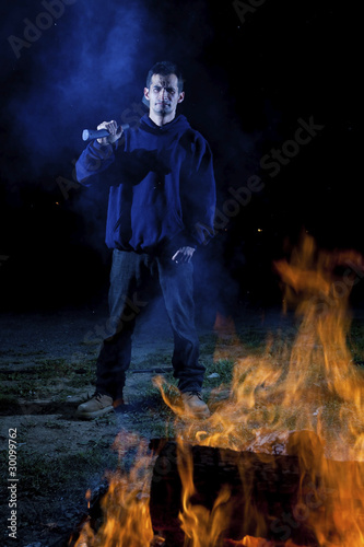 Axe wielding maniac by a fire