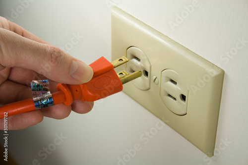 Plugging Electrical Cord into Wall Outlet