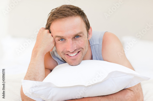 Man lying down on his bed