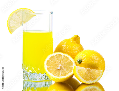 Fresh lemon and fresh lemon juice in a glass