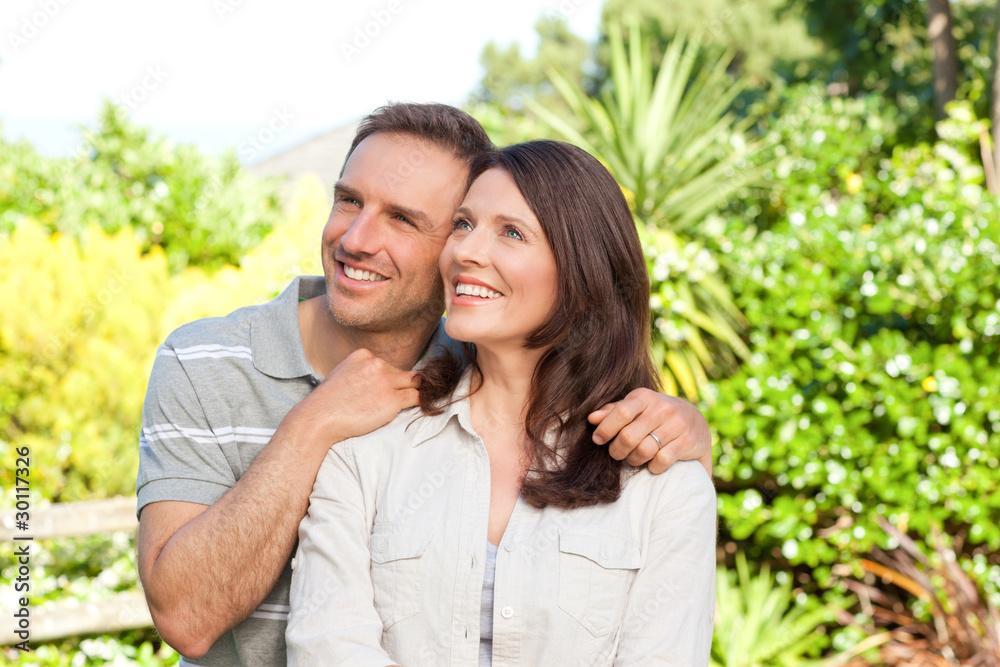 Beautiful woman with her husband in the garden Beautiful woman with her husband in the garden