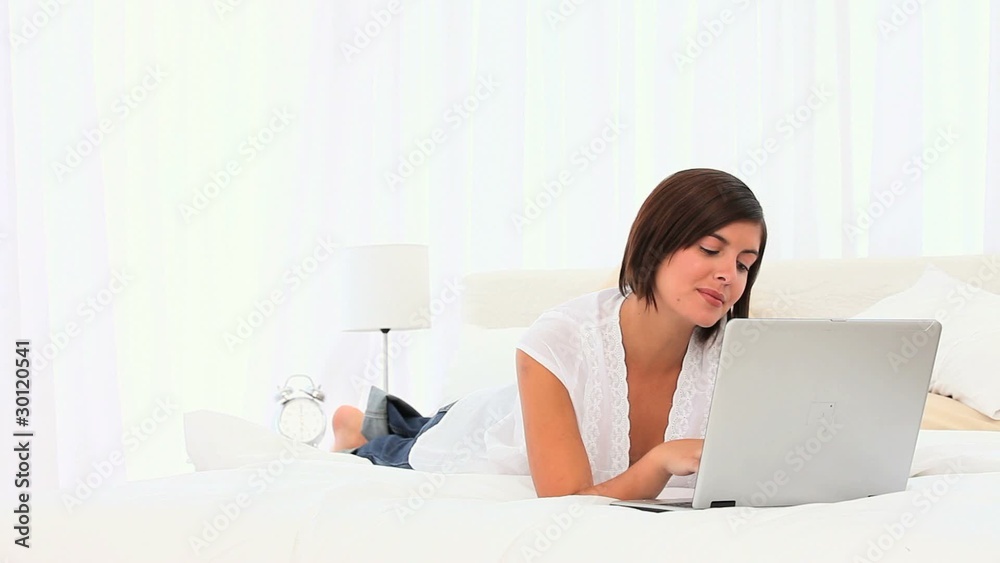Brunette enjoying a chat on her laptop Brunette enjoying a chat on her laptop