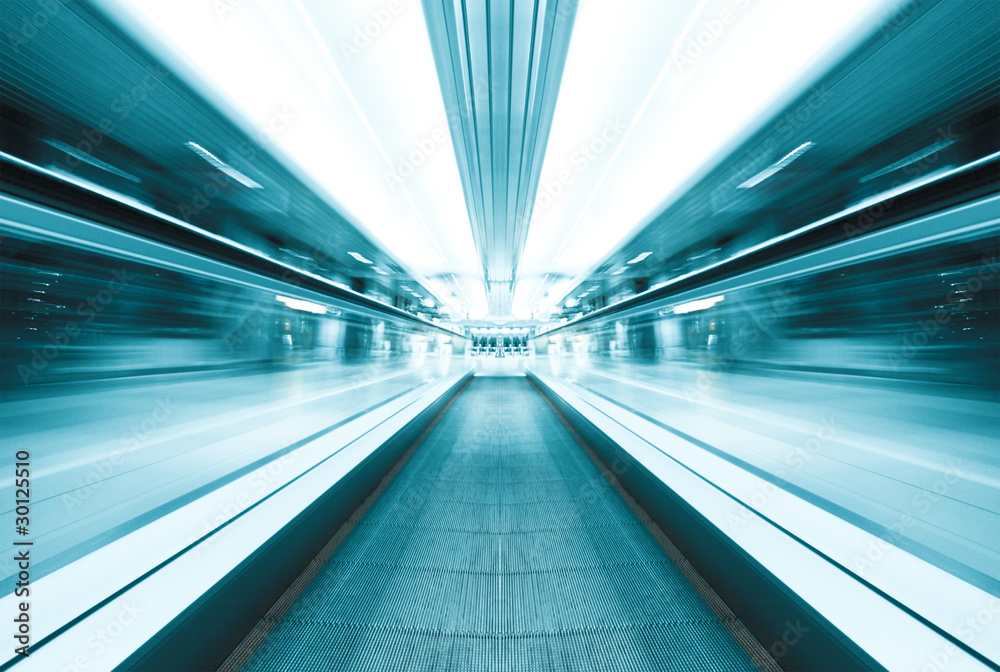 symmetric moving blue escalator inside contemporary airport
