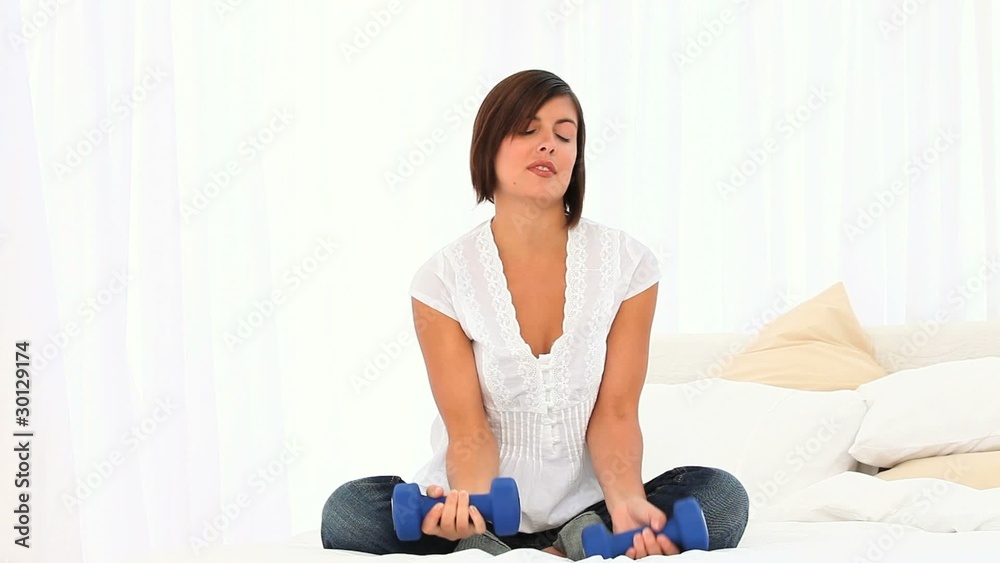 Casual woman using dumbbells Casual woman using dumbbells
