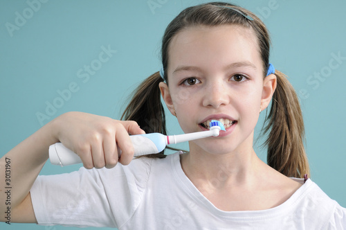 teenager washing teeth with toothbrush
