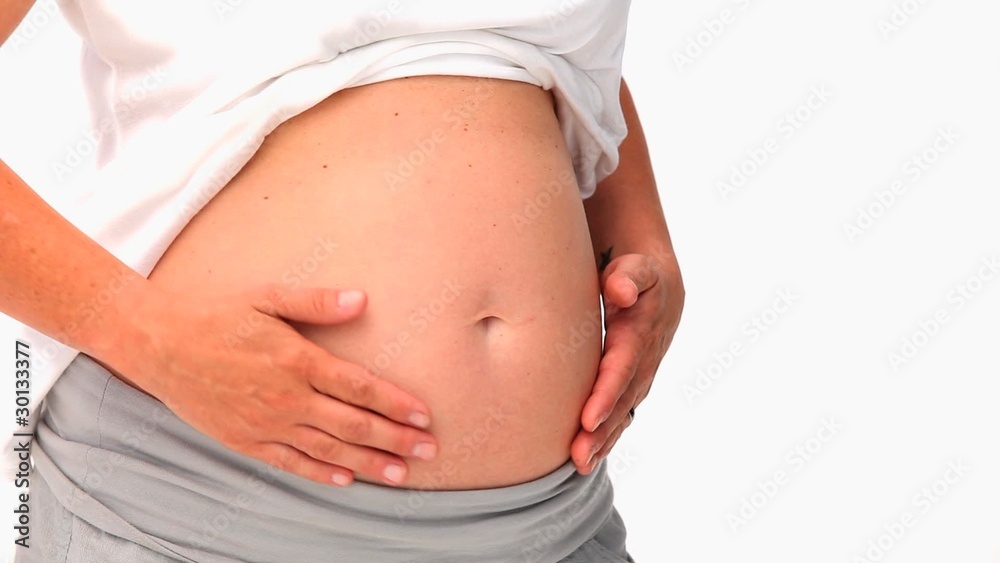 Pregnant woman stroking her belly Pregnant woman stroking her belly