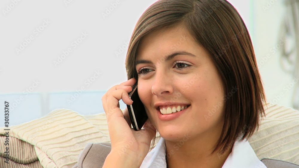 Casual brown-haired woman talking on the phone Casual brown-haired woman talking on the phone