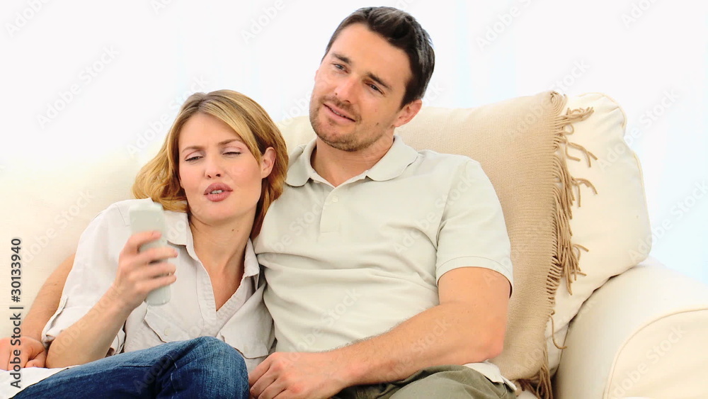 Casual young couple looking at the tv