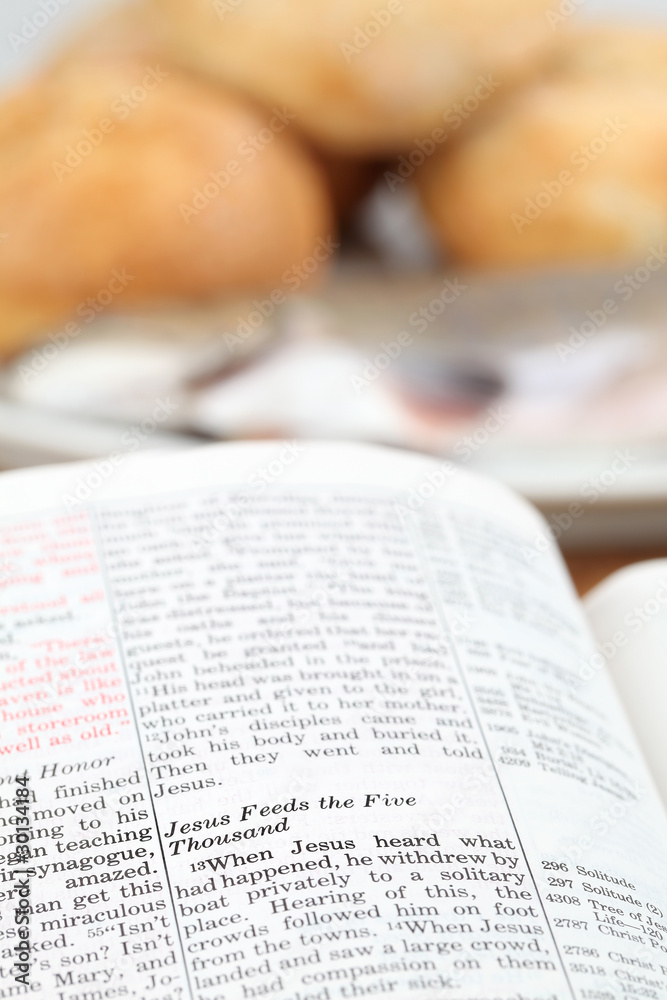 Fototapeta premium Bible with text in Matthew 14 - Feeding the five thousand