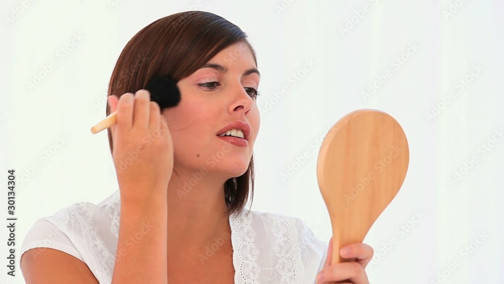 Brown-haired lady putting on make-up Brown-haired lady putting on make-up
